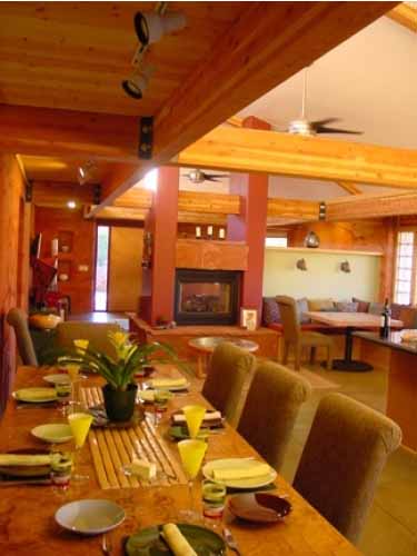 Dining area with view of fireplace in the great room of a Poured Earth home in Sedona, AZ
